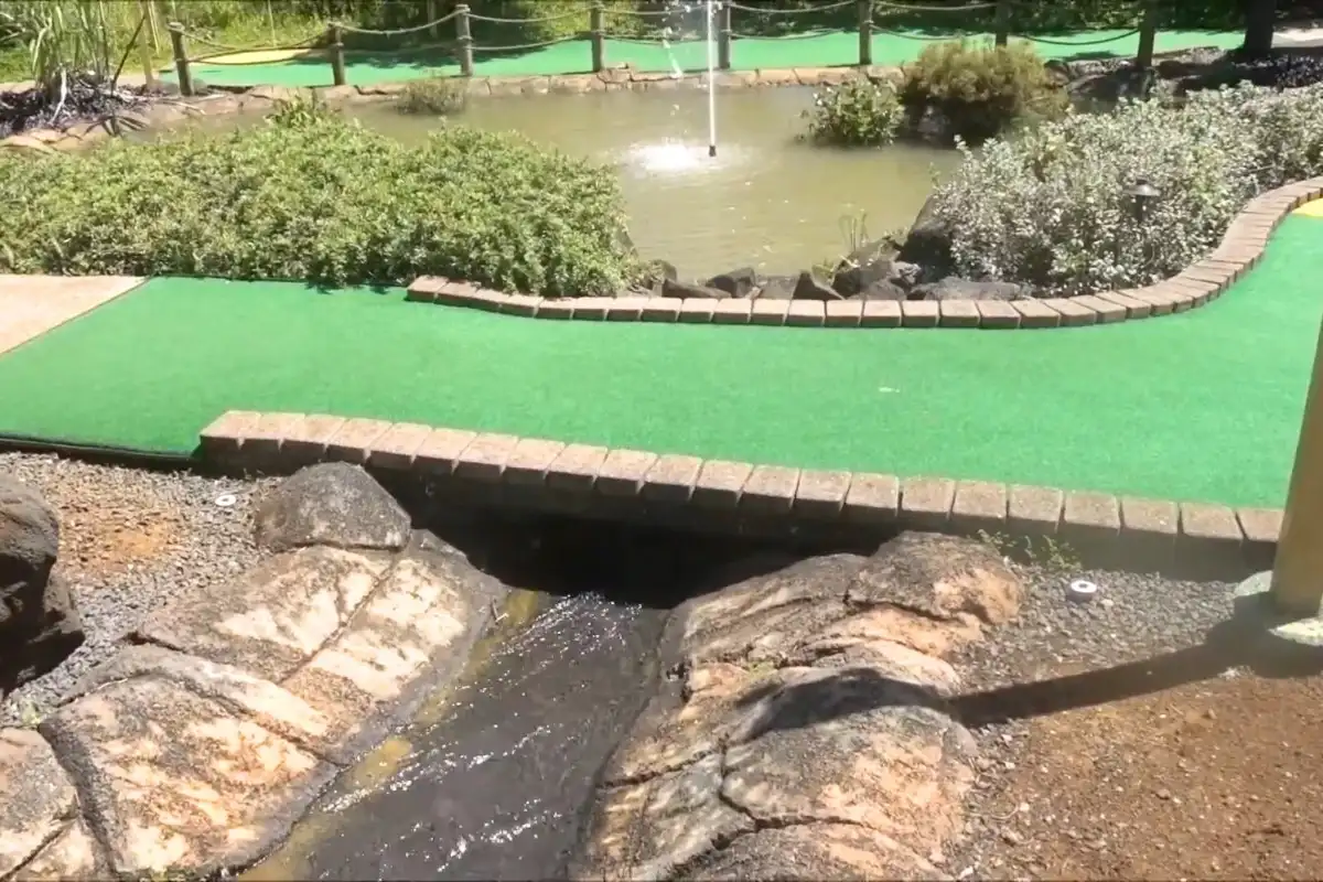 Discover Kauai Mini Golf at Anaina Hou Park, where fun meets nature % Water crossing under the truffe of mini golf at Kauai
